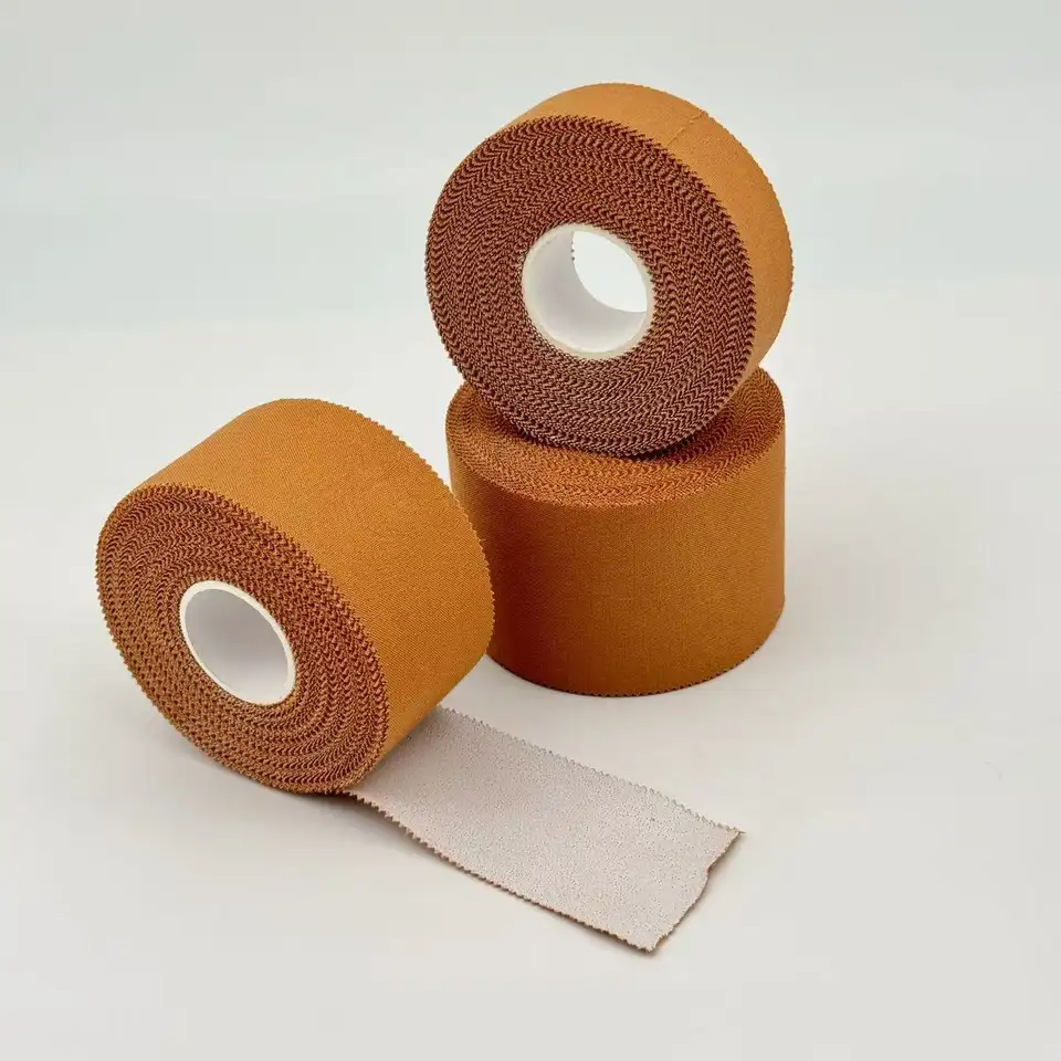 Close-up of tan rigid strapping tape rolls showing rayon texture and serrated edges