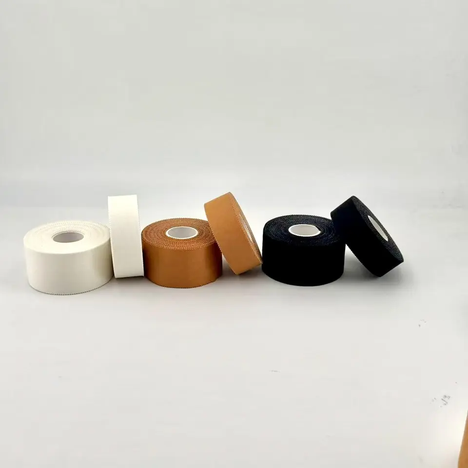Rigid strapping tape rolls in three standard colors: white, tan/skin, and black