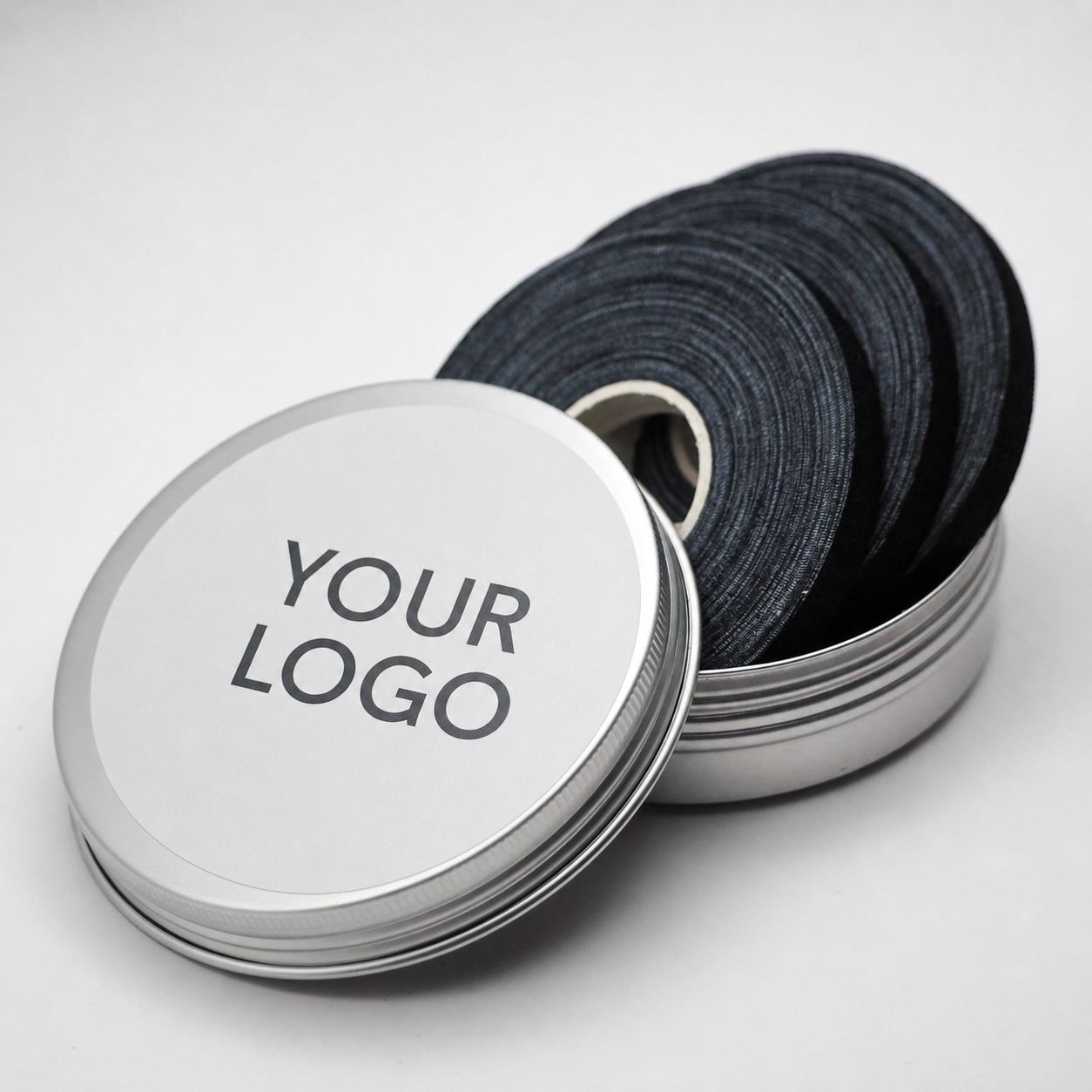 Open silver metal tin with cotton finger tape rolls inside — custom OEM packaging options