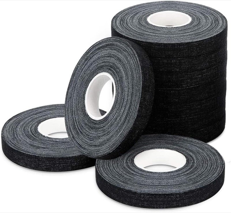 Multiple rolls of black athletic tape on a white background